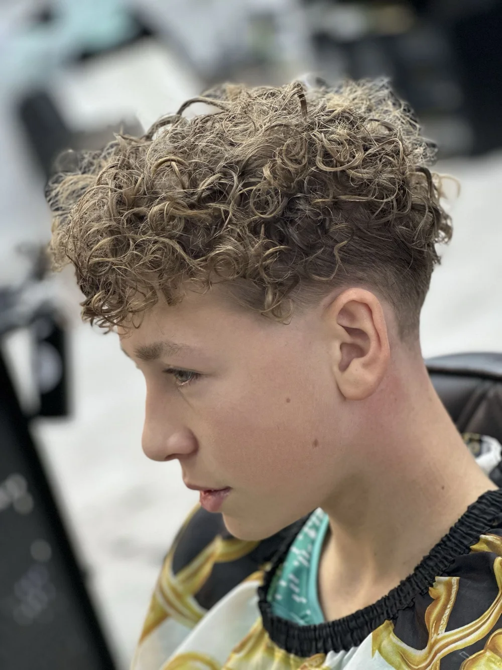 Finished curly perm with a skin fade on a young man at Prestige Gentleman