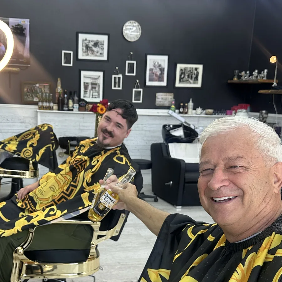 Clients relaxing in the gold barber chairs at the studio