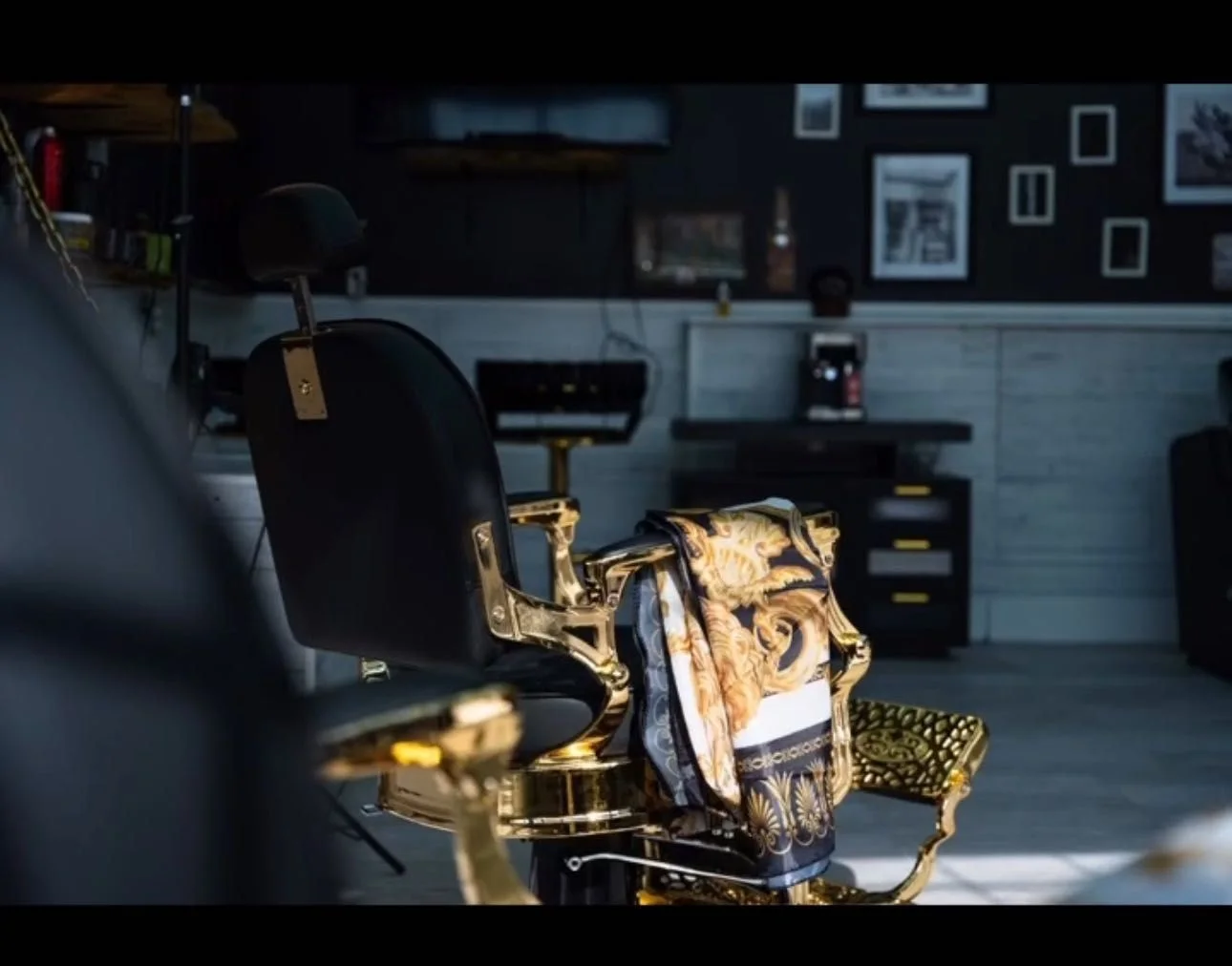 Black and gold interior of Prestige Gentleman Hair Studio with a vintage gold barber chair, Innisfil Ontario